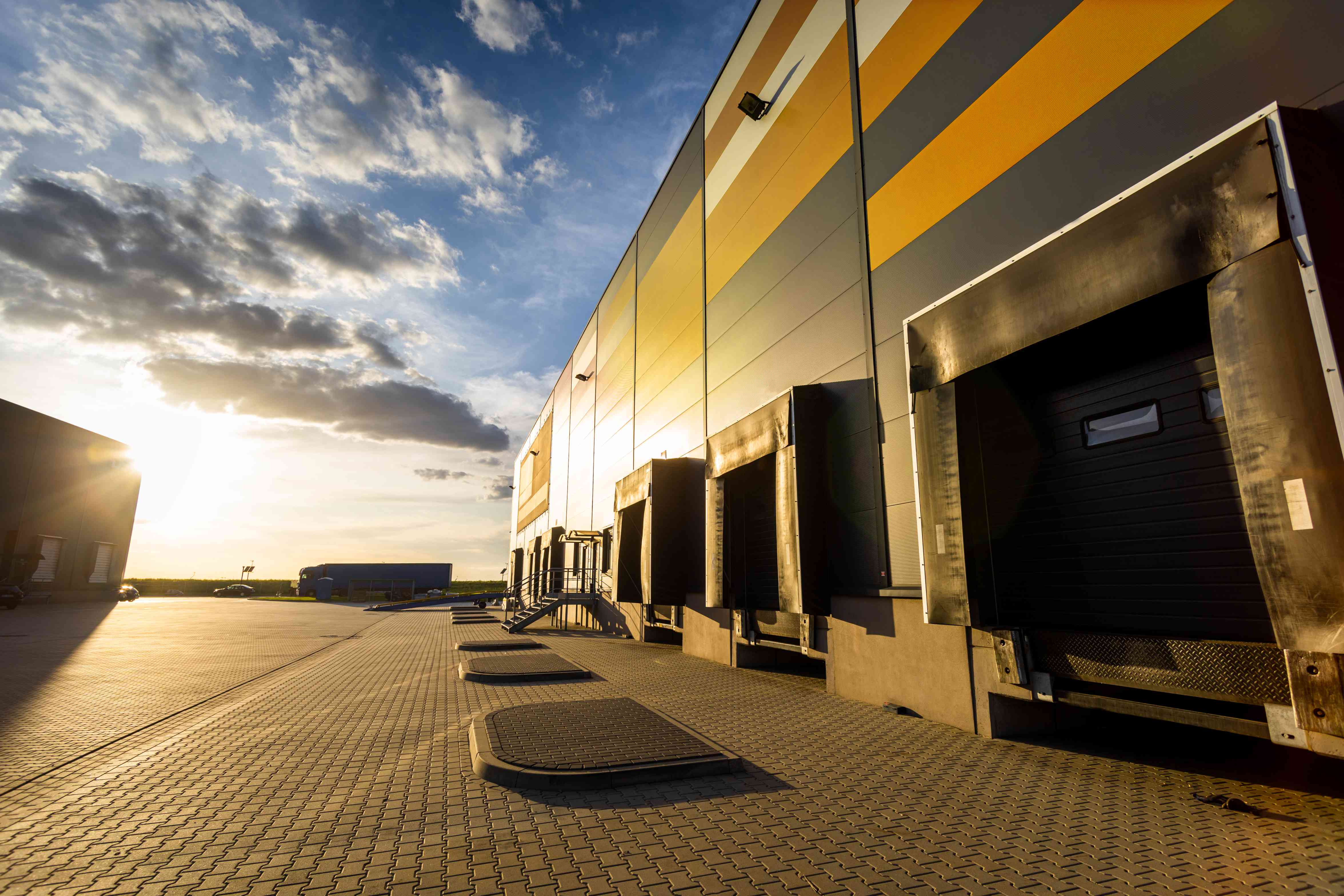 cargo-loading-dock-doors-of-big-warehouse-building-8RFZSZE(1) Dock Levelers: The Most Important Loading Dock Equipment
